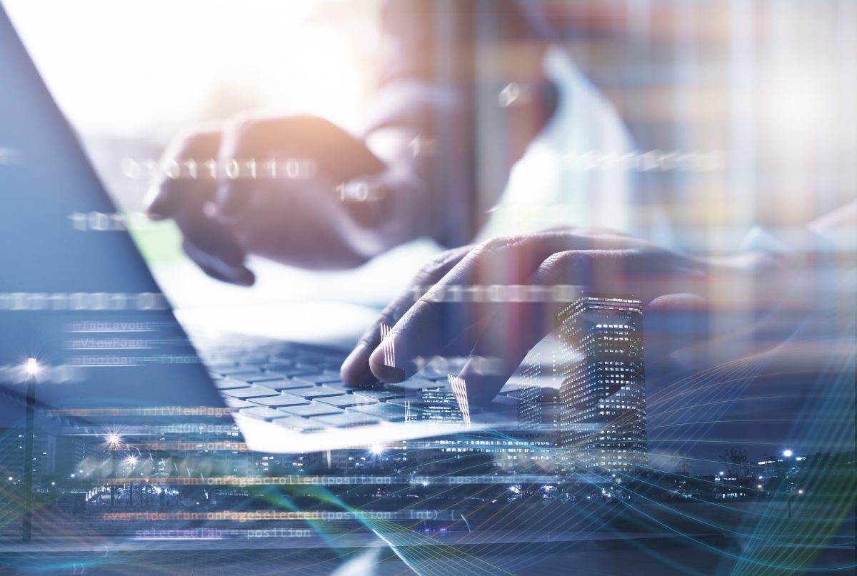 Digital software development, Big Data technology, IoT Internet of Things concept. Double exposure software developer working on laptop computer and smart city with programming code and hologram interface