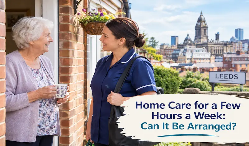 Carer and older woman hanging washing together in a back garden during a short home care visit